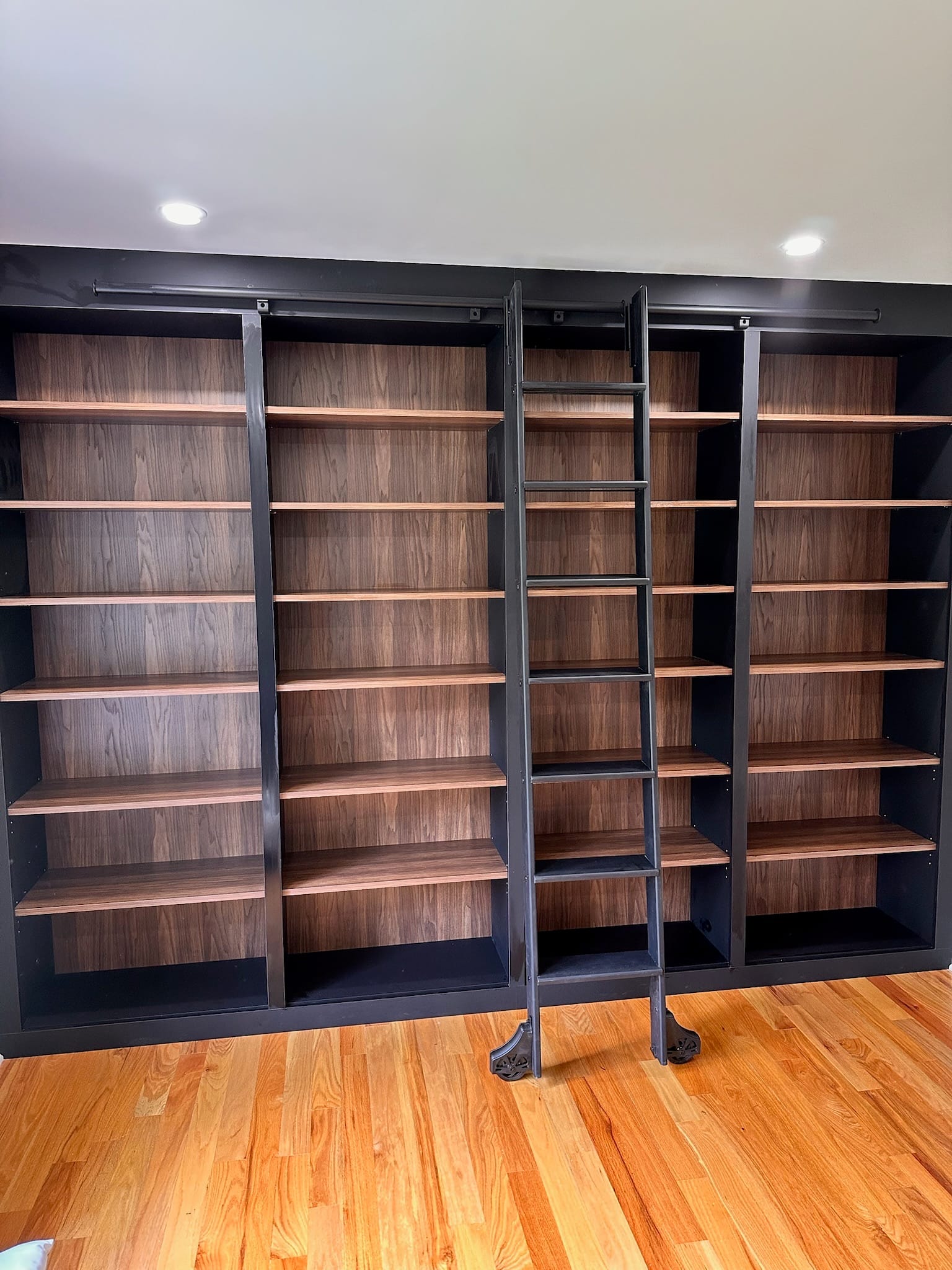 built in book shelf with ladder